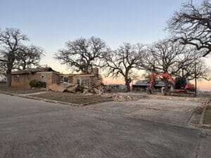 Dozer demolishing a house.