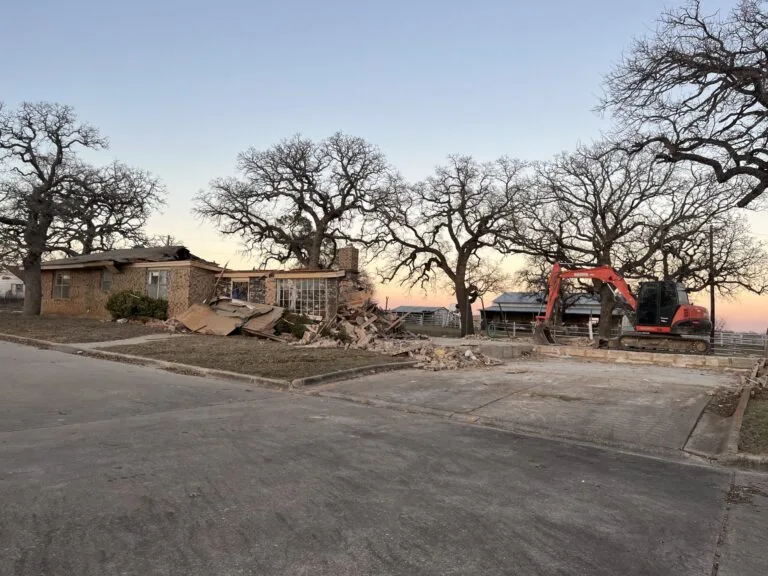 Dozer demolishing a house.