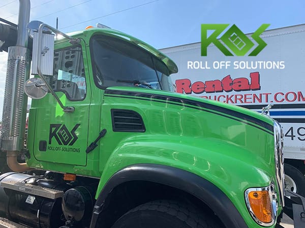 Roll Off Solutions passing another friendly rental truck in Denton County