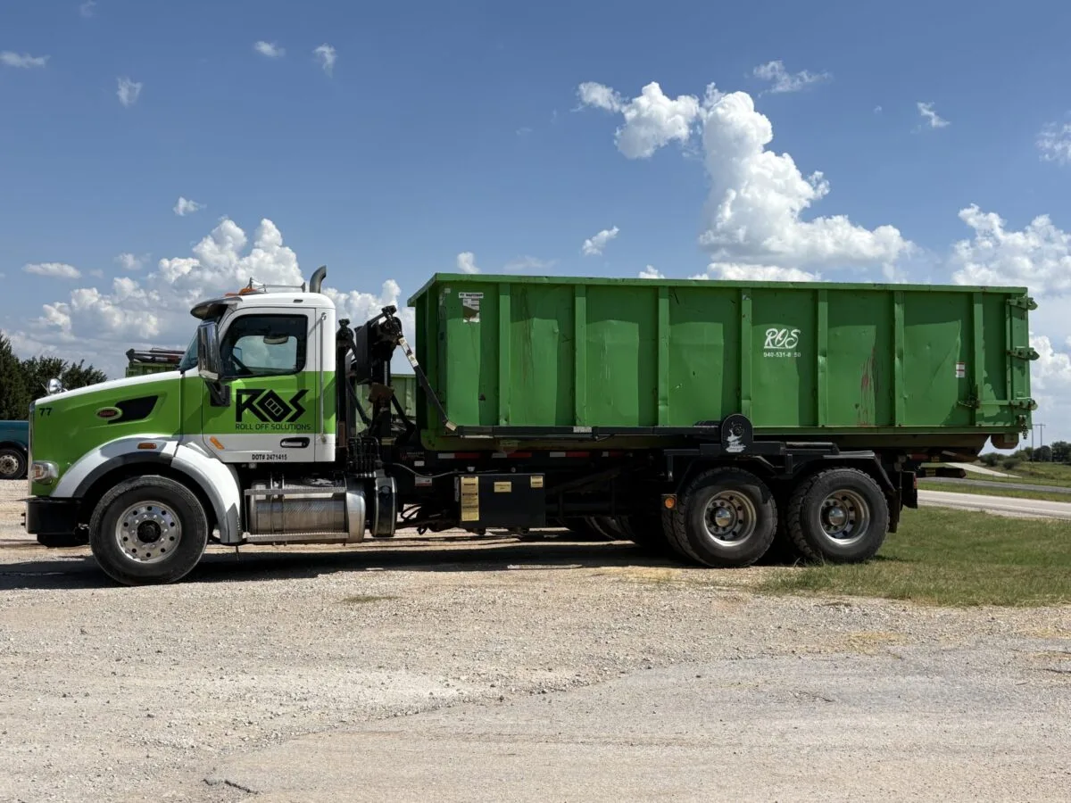 Roll Off Solutions Truck with large dumpster rental at 6826 US HWY 287 N Bowie, Tx 76230